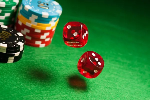 Close-up of live dealer handling cards and chips at a professional gaming table